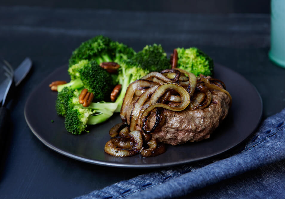 Grilled Grass-Fed Beef Burger with Caramelized Onions and Pecan Broccoli