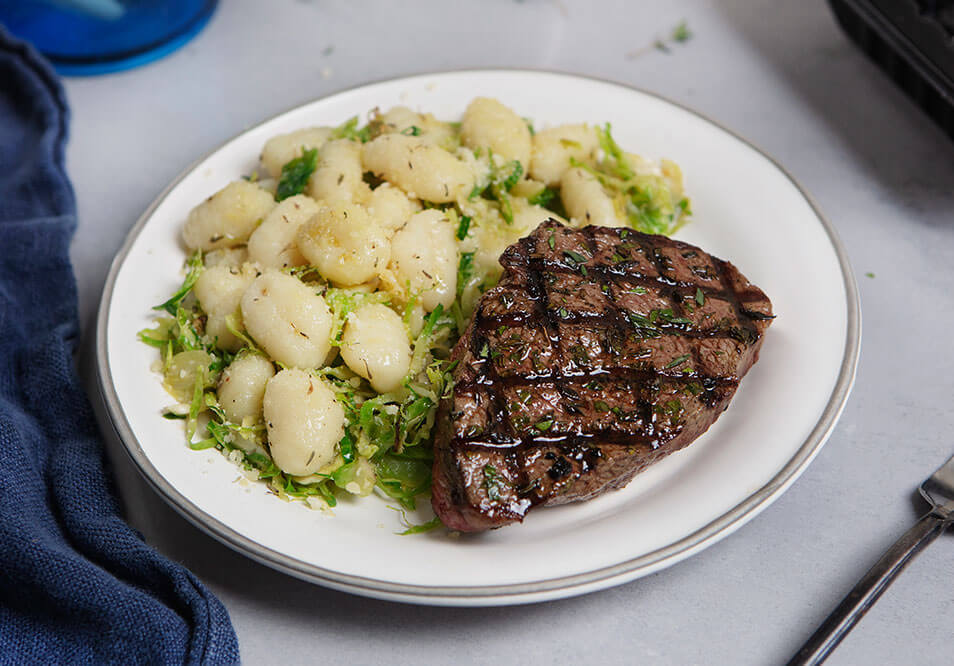 Grilled Grass-Fed Top Steak and Rustic Potato Gnocchi with Brown-Butter Brussels Sprouts